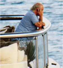  ??  ?? On call: Sir Philip Green talks on the phone yesterday