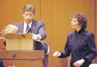  ?? ?? Los Angeles Police Detective Mark Fuhrman shows the jury in the O.J. Simpson double murder trial evidence found in the white Bronco that prosecutor­s contend defendant O.J. Simpson drove the night his ex-wife and a friend were murdered, during testimony Friday, March 10, 1995, in Los Angeles. Prosecutin­g attorney Marcia Clark looks on.