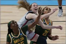  ?? ERIC GAY — THE ASSOCIATED PRESS ?? UConn guard Paige Bueckers, center, drives between Baylor defenders Queen Egbo (25) and DiJonai Carrington (21) on March 29 in San Antonio.