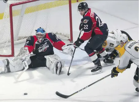  ?? DAN JANISSE ?? Spitfires goalie Michael DiPietro and teammate Thomas Stevenson defend against Adam Ruzicka of the Sarnia Sting Thursday.