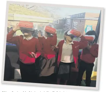  ??  ?? Children at Dogsthorpe Infant School wearing the Virtual Reality headsets