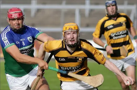  ??  ?? Shane Lawlor of Rathnure tries to make progress as John Leacy (Glynn-Barntown) closes him down.