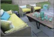  ?? KRISTINA CRESTIN VIA AP ?? This undated photo provided by Kristina Crestin shows an outdoor space in Essex, Mass., designed by Crestin. One key to enjoying your outdoor living space in chilly fall weather: Sofas and chairs with deep, padded seats. In this backyard patio deep...