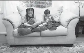  ??  ?? Juliana Sanchez, 5, and her brother, Francisco, 2, watch children’s programmin­g on YouTube on their parents’ cellphones. (Photo: Bay Area News Group/TNS)