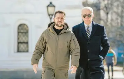  ?? DANIEL BEREHULAK/THE NEW YORK TIMES ?? President Joe Biden, right, is escorted by President Volodymyr Zelenskyy of Ukraine as he visits Kyiv, Ukraine’s embattled capital, on Feb. 20.