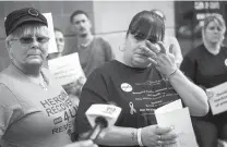  ?? JOHN MINCHILLO/ASSOCIATED PRESS ?? Christel Brooks of Cincinnati wipes a tear on Sept. 11 as heroin awareness and advocacy groups met at Hamilton County Justice Center to demand action after a wave of overdoses.