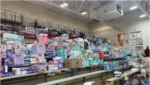  ?? RIGHT ?? Diapers are stacked inside the gym at Indian Lake High on Saturday in Indian Lake, Logan County, Ohio. The high school has become a donation center after a tornado swept through the Indian Lake area Thursday. in Indian Lake, in Logan County, Ohio. The Indian Lake area in Ohio’s Logan County was one of the hardest hit (AP Photo/ Patrick Orsagos)