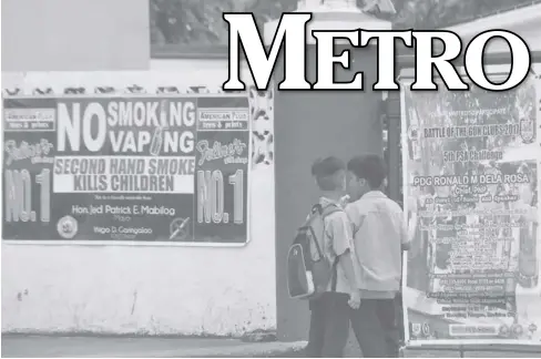  ?? JOSELITO VILLASIS/PN ?? NOT FOR KIDS. Two elementary pupils read a sign warning against smoking posted outside the gate of Camp Martin Delgado in Fort San Pedro on Tuesday, July 18. President Rodrigo Duterte’s executive order banning smoking in public areas will be...