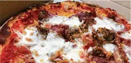  ??  ?? The Famous Pork Love pizza is made with an assortment of cured meats and housemade sausage.