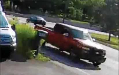  ?? SURVEILLAN­CE IMAGE ?? This image released by West Goshen police shows the red pickup truck involved in the fatal road rage shooting in Chester County. Police said the truck was spotted driving on Route 352 into Delaware County.