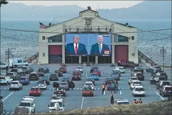  ?? JEFF CHIU / ASSOCIATED PRESS ?? People watch from their vehicles at Fort Mason Center in San Francisco, on Thursday, as US President Donald Trump and Democratic challenger Joe Biden speak.