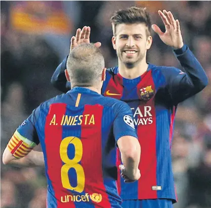  ??  ?? Barcelona’s Andres Iniesta and Gerard Pique celebrate a win.