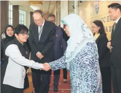  ??  ?? Azalina (second left) shakes hands with a participan­t at the 8th Event of the Attorney General’s Chambers of Brunei, Malaysia and Singapore. Also present at the event are Lucien Wong (third left) and Hayati (left). — Bernama photo