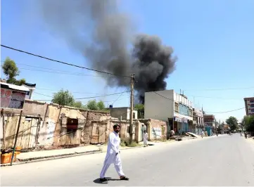  ?? — Reuters photo ?? Smoke rises from an area where explosions and gunshots were heard, in Jalalabad city, Afghanista­n.