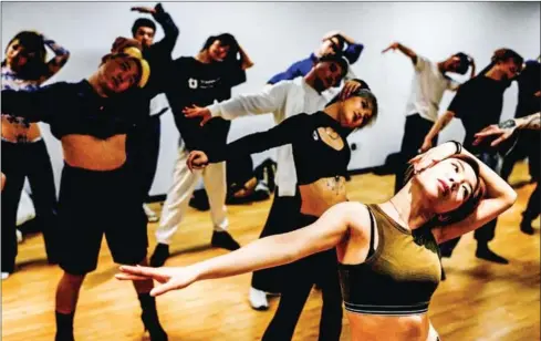  ?? AFP ?? Students stretch during a voguing dance course in preparatio­n for a voguing ball in Beijing on Friday.