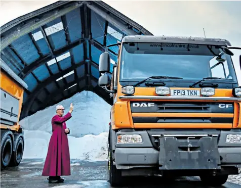  ??  ?? The Bishop of Grimsby, the Rt Rev David Court, blesses gritters at Sturton-by-stow depot, Lincolnshi­re, ahead of them working through the anticipate­d cold winter weather
