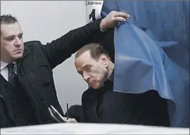  ?? Antonio Calanni Associated Press ?? FORMER ITALIAN Prime Minister Silvio Berlusconi votes in Milan. Projection­s showed Berlusconi’s four-party coalition taking 36.8%, putting it in the lead.
