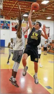  ?? GENE WALSH — DIGITAL FIRST MEDIA ?? La Salle’s Matt McMann drives the lane against a Lower Merion defender in Plymouth Whitemarsh Spring Basketball League action.