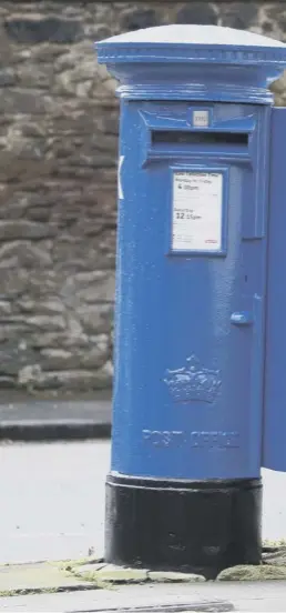  ??  ?? 0 A young boy cycles past one of the specially decorated postboxes in Edinburgh painted blue in support of NHS workers and carers fighting the coronaviru­s pandemic