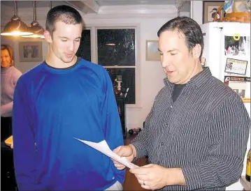  ?? STAFF PHOTO BY JOHN WHARTON ?? Michael Roberts and his stepfather, Jimmy Dicus, reflect on their good fortune, and reviewed a list of water safety tips, after the younger man’s canoeing mishap in 2012 on the Patuxent River.