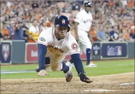  ?? The Associated Press ?? Houston Astros’ George Springer scores on teammate Alex Bregman’s hit during the seventh inning of Game 1 of their ALDS playoff series against the Cleveland Indians on Friday in Houston. The Astros won 7-2.