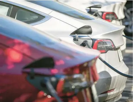  ?? CHRIS URSO/TAMPA BAY TIMES ?? Tesla electric vehicles are lined up at charging stations Feb. 16 at a gas station in Clearwater.