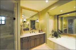  ?? THINKSTOCK ?? Decorative tile around the mirror adds a design element to this bathroom.