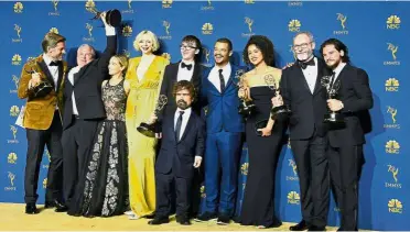  ?? — AFP ?? Taking the Emmy throne: The cast of ‘Game of Thrones’ posing with the Emmy for Outstandin­g Drama Series during the 70th Emmy Awards at the Microsoft Theatre in Los Angeles.