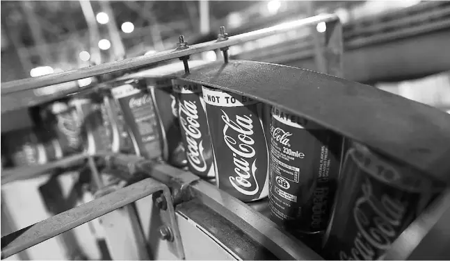  ?? Chris Ratcliff
e / Bloom
berg News files ?? Coca-Cola has promised that it will sell off its bottling operations but investors are contending the process is not occurring quickly enough.