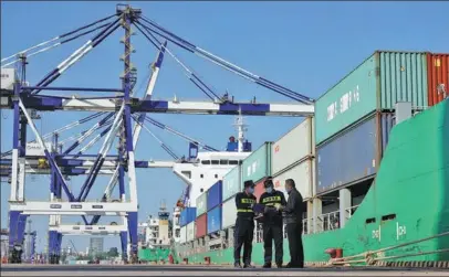  ?? TANG KE / FOR CHINA DAILY ?? Customs officers verify documentat­ion related to foreign trade containers at an internatio­nal container terminal of Yantai Port in Shandong province on Oct 12. China’s foreign trade in goods soared 22.7 percent year-on-year in the first nine months.