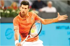 ?? — AFP photo ?? Djokovic returns the ball to Monfils during their ATP Tour Madrid Open tennis tournament singles match at the Caja Magica in Madrid.
