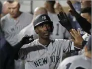  ?? TED S. WARREN - THE ASSOCIATED PRESS ?? FILE - In this Sept. 7, 2018, file photo, New York Yankees’ Andrew McCutchen is greeted in the dugout after he hit a two-run home run during the third inning of a baseball game against the Seattle Mariners, in Seattle.