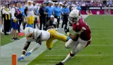  ?? Associated Press ?? Cardinals running back James Conner scores a touchdown as Chargers linebacker Kenneth Murray Jr. defends during the second half Sunday in Glendale, Ariz.