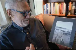  ?? ALAN DEP — MARIN INDEPENDEN­T JOURNAL ?? Vietnam veteran Dean Echenberg holds a photo of himself during his time in the Air Force at his home in Tiburon. Echenberg is the executive producer of the documentar­y “The Misty Experiment: The Secret Battle for the Ho Chi Minh Trail.”