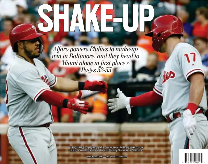  ?? PATRICK SEMANSKY — THE ASSOCIATED PRESS ?? The Phillies’ Jorge Alfaro, left, celebrates with Rhys Hoskins after hitting a solo home run in the sixth inning Thursday in Baltimore.