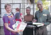  ??  ?? COURTESY OF THE WEST TENNESSEE HAITI PARTNERSHI­P Dr. Susan Nelson, a volunteer physician with West Tennessee Haiti Partnershi­p, delivers a flute and sheet music to Myrielle Julian, 15, outside Holy Trinity Cathedral in Port au Prince. Myrielle’s dad,...