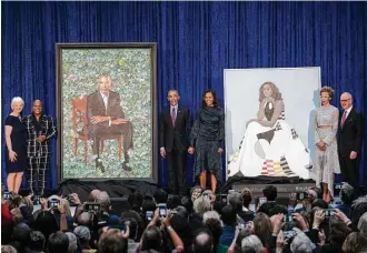  ?? Gabriella Demczuk / New York Times ?? Former President Barack Obama and wife Michelle join the artists who painted their official portraits Monday at the National Portrait Gallery in Washington.