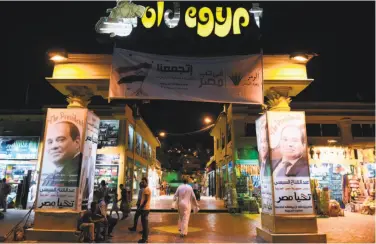  ?? Mohamed El-Shahed / AFP / Getty Images ?? Posters of Egyptian President Abdel Fattah el-Sissi adorn a deserted tourist market in Sharm el-Sheikh.