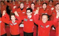  ?? Yonhap ?? Members of the ruling People Power Party (PPP), including its interim leader Han Donghoon, front row center, hold their arms up during a launching ceremony of the party’s election campaign committee at the National Assembly in Seoul, Tuesday.