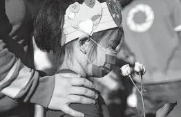  ?? Yi-Chin Lee / Staff file photo ?? Hong Jiang and her daughter Annie, 6, take part in the “Stop Asian Hate Vigil and Rally” at Discovery Green on March 20, after six Asian American women were killed in the Atlanta area.