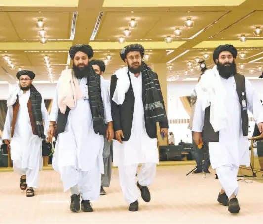  ?? HUSSEIN SAYED/AP ?? THE TALIBAN delegation arrives to sign the peace agreement with U.S. officials in Doha on February 29.