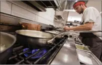  ?? DAI SUGANO — BAY AREA NEWS GROUP ?? A junior sous-chef Nicholas Sexton cooks using a gas stove in the kitchen on May 27, in Campbell.