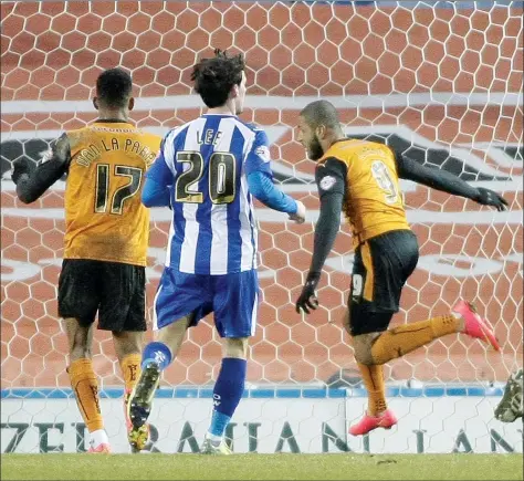  ?? PICTURES: Media Image Ltd ?? TIMELY FINISH: Leon Clarke pounces to give Wolves all three points