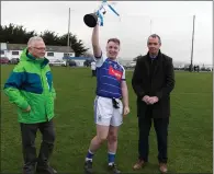  ??  ?? Éire Óg’s Eoghan McTague lifts the Paudge Dooley Memorial Cup after helping his side to victory over Rathnew.