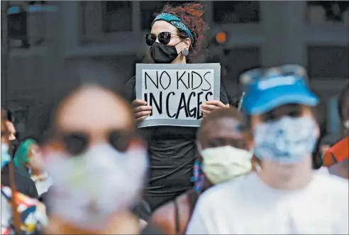  ?? JOHN J. KIM/CHICAGO TRIBUNE ?? A protester holds a sign during a rally July 10 at Daley Plaza in Chicago to call attention to the ICE detention of children and families.