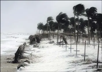  ?? Kamran Jebreili The Associated Press ?? Debris and sea foam crash a beach in the aftermath of Cyclone Mekunu in Salalah, Oman, on Saturday. The cyclone blew into the Arabian Peninsula, drenching arid Oman and Yemen with rain and cutting off power lines.