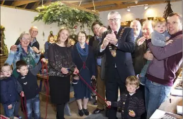  ??  ?? Lennie Wall officially cutting the ribbon to open her ‘Wallflower’ shop in Ballyculla­ne.