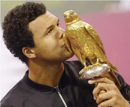  ??  ?? Flying high: Jo-wilfried Tsonga kissing the Qatar Open trophy after defeating his French compatriot Gael Monfils in the final in Doha on Saturday. – Reuters