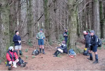  ??  ?? Above: The group stops for a chat and bite to eat among the pine trees. Below: After all the rain during the season there was a stretch of water on the road.