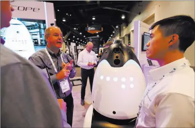  ?? Todd Prince ?? Las Vegas Review-journal Knightscop­e employees explain their robots to GSX attendees Wednesday at the Las Vegas Convention Center.